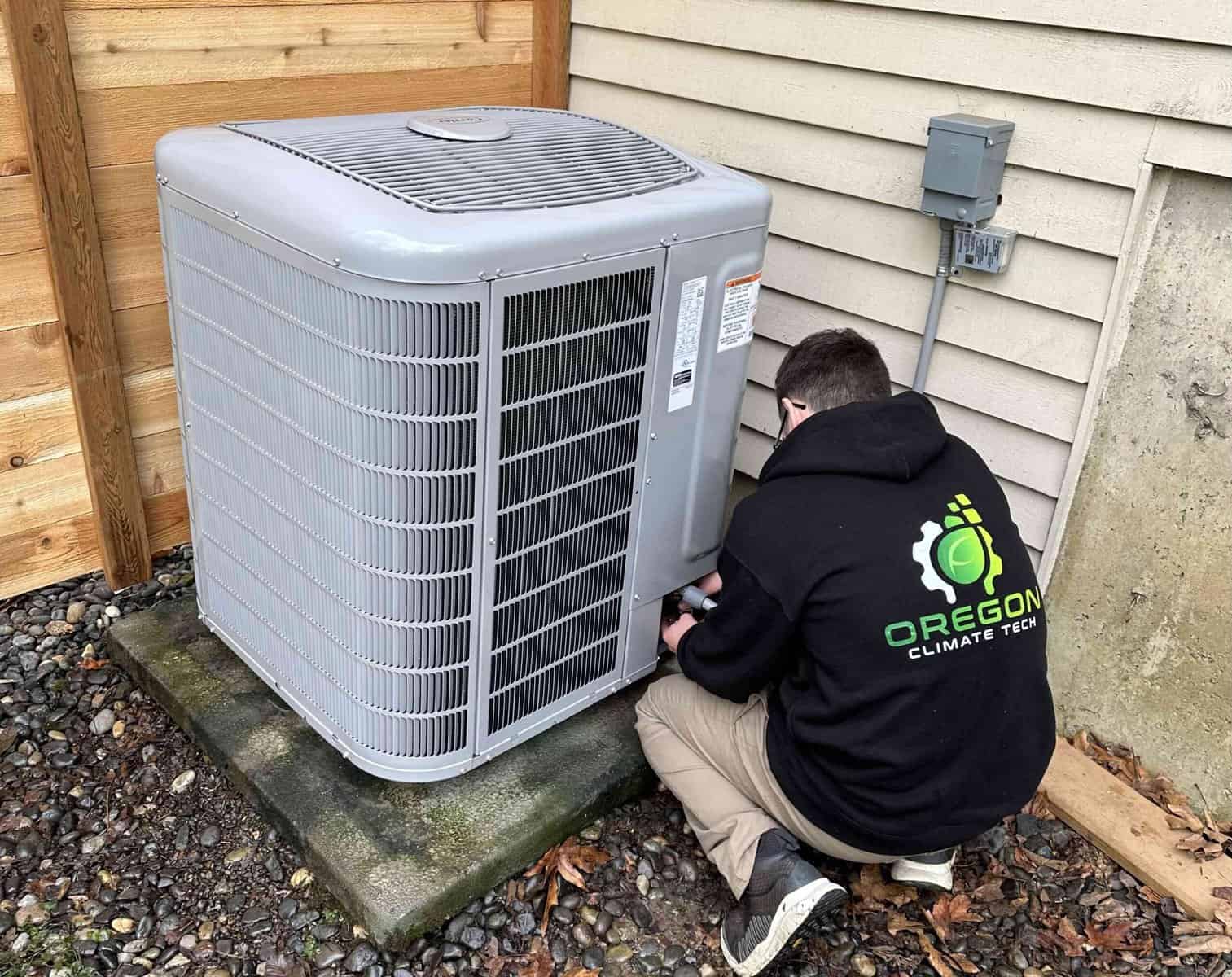 Oregon Climate Tech technician diagnosing an outdoor AC condenser at a Portland home.