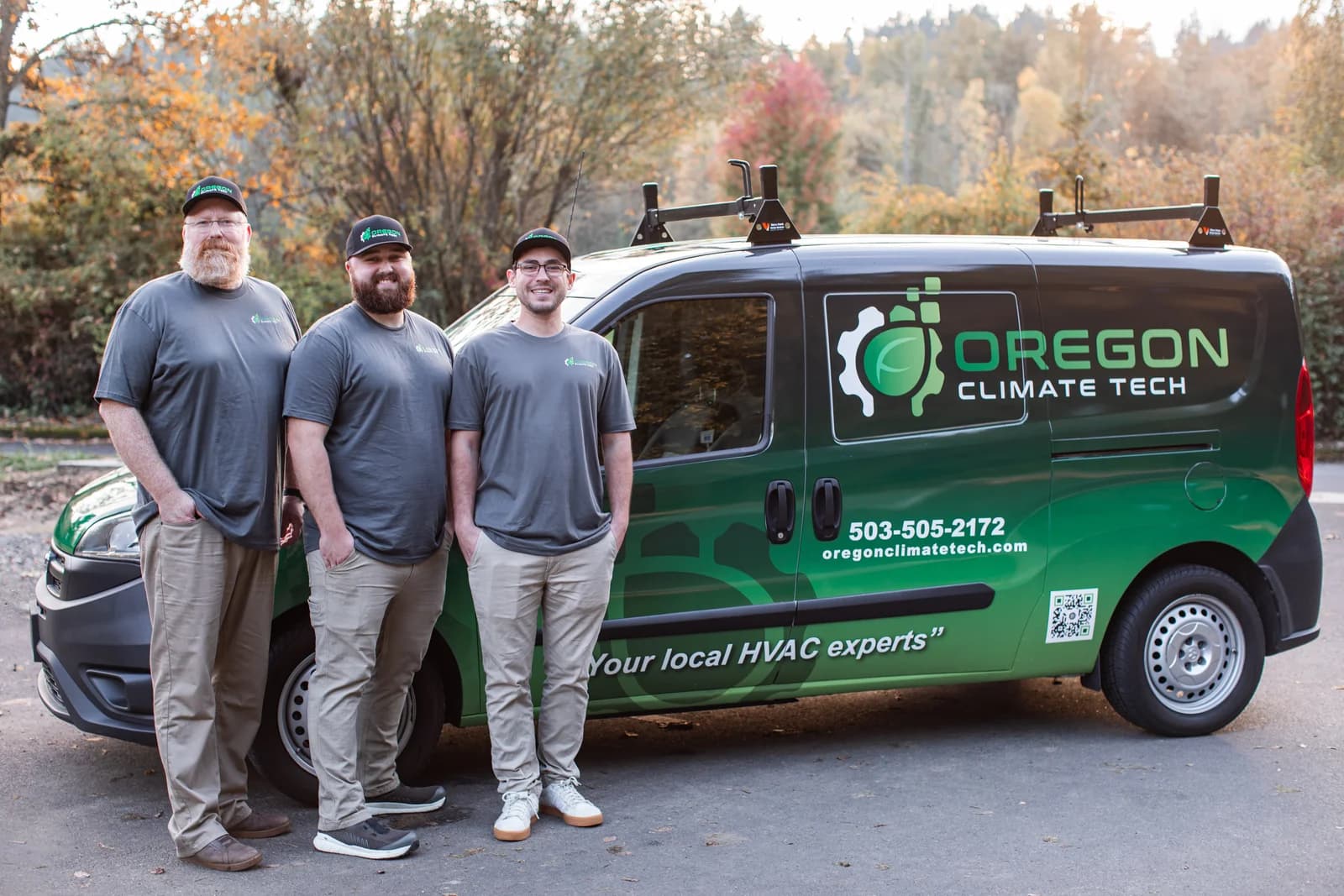The three Oregon Climate Tech founders — Jason Morris, Tristin Morris, and Adam Eells — standing in front of a branded OCT service van.