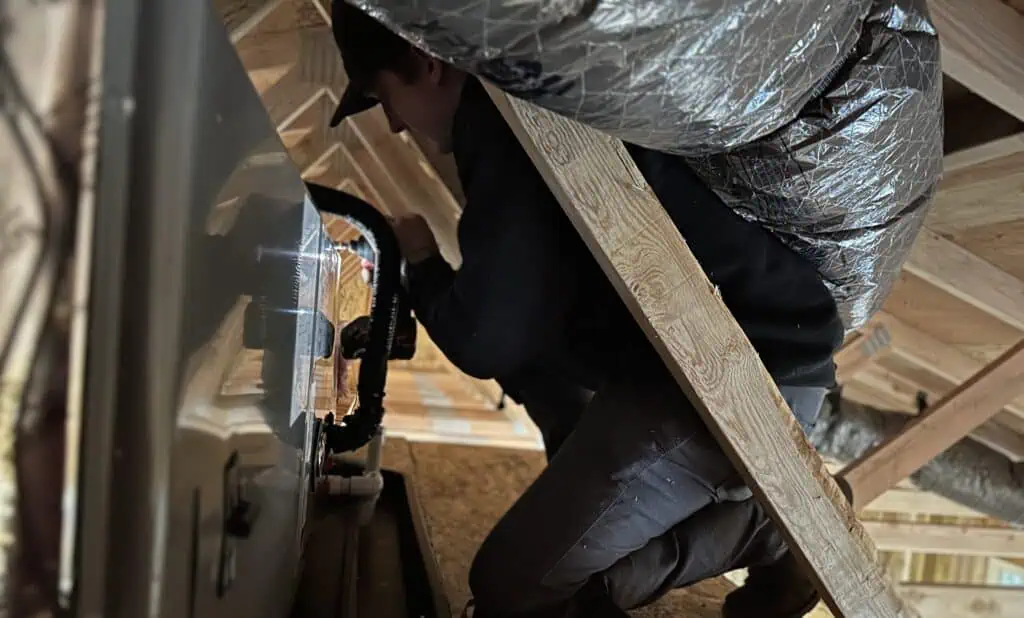 HVAC ductwork and furnace installation in an attic.
