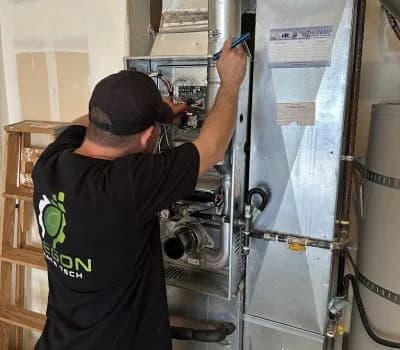 Oregon Climate Tech installer wiring a high-efficiency furnace at a Portland home.