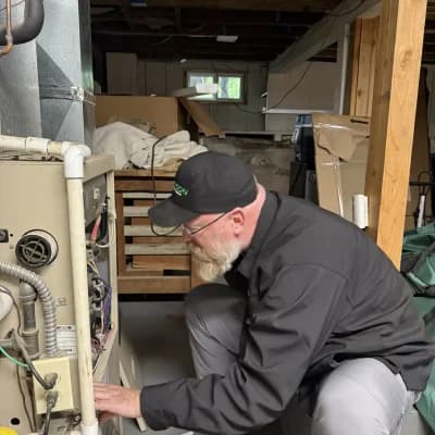 Oregon Climate Tech technician repairing a furnace.