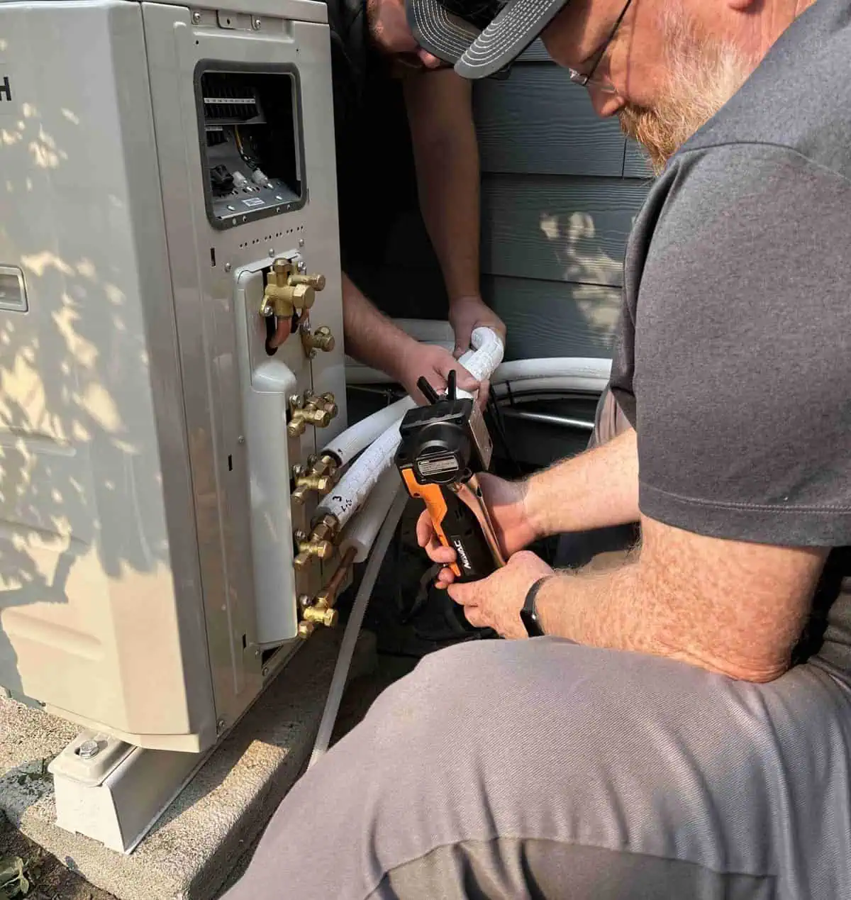 Oregon Climate Tech installing a ductless outdoor heat pump system.