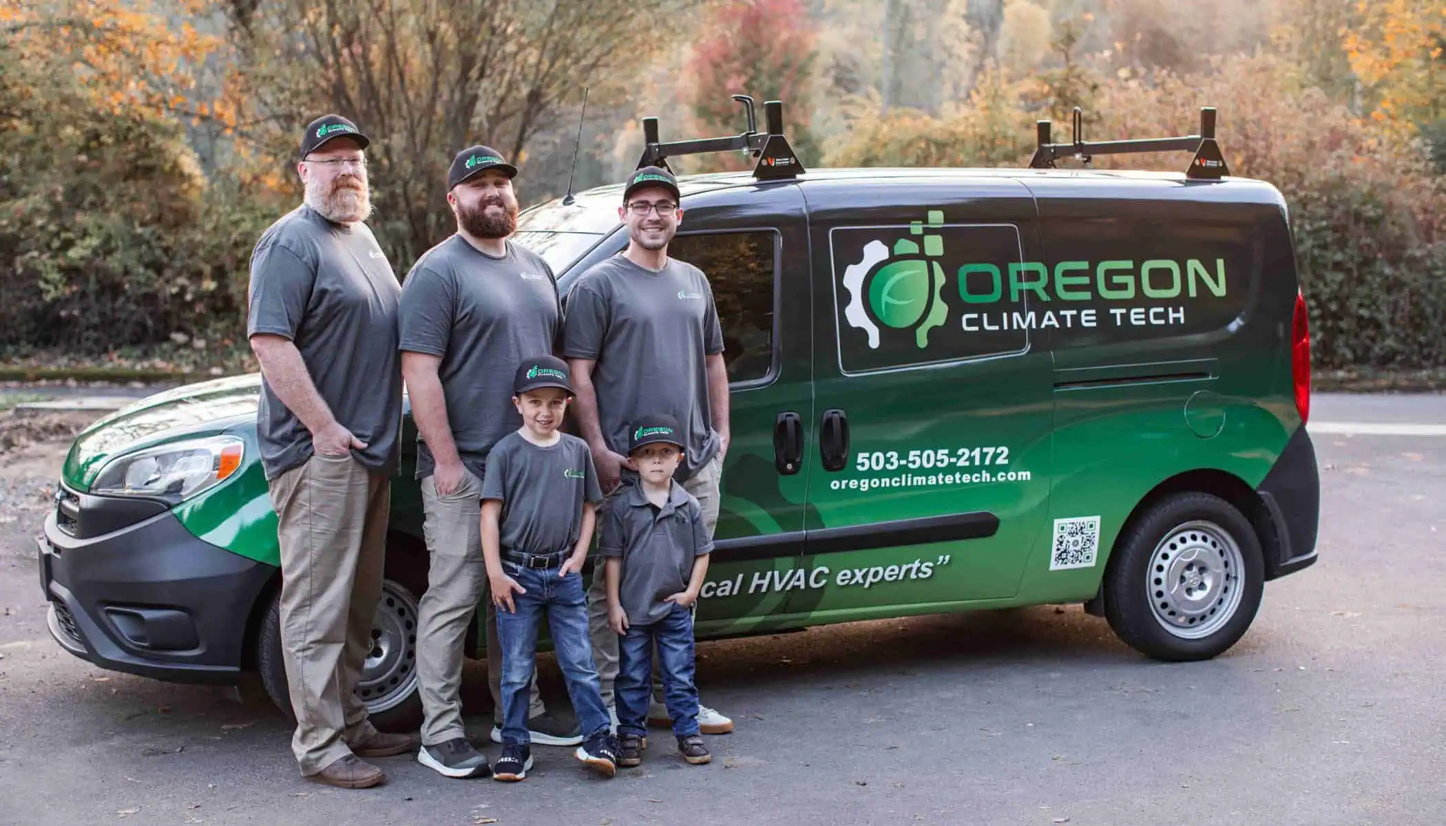 Oregon Climate Tech team members standing near a branded OCT service van.