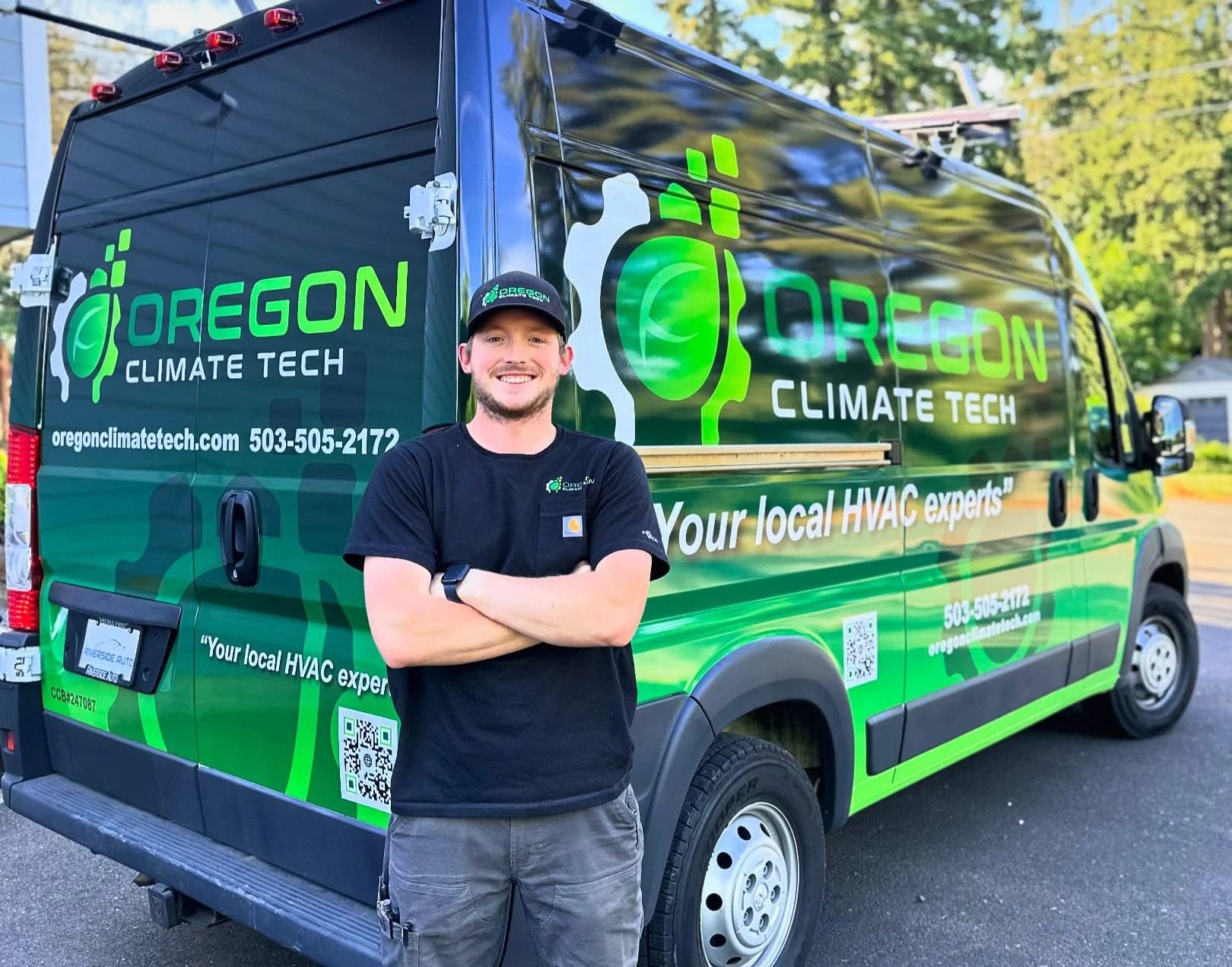 An Oregon Climate Tech technician standing in front of a branded company service van.