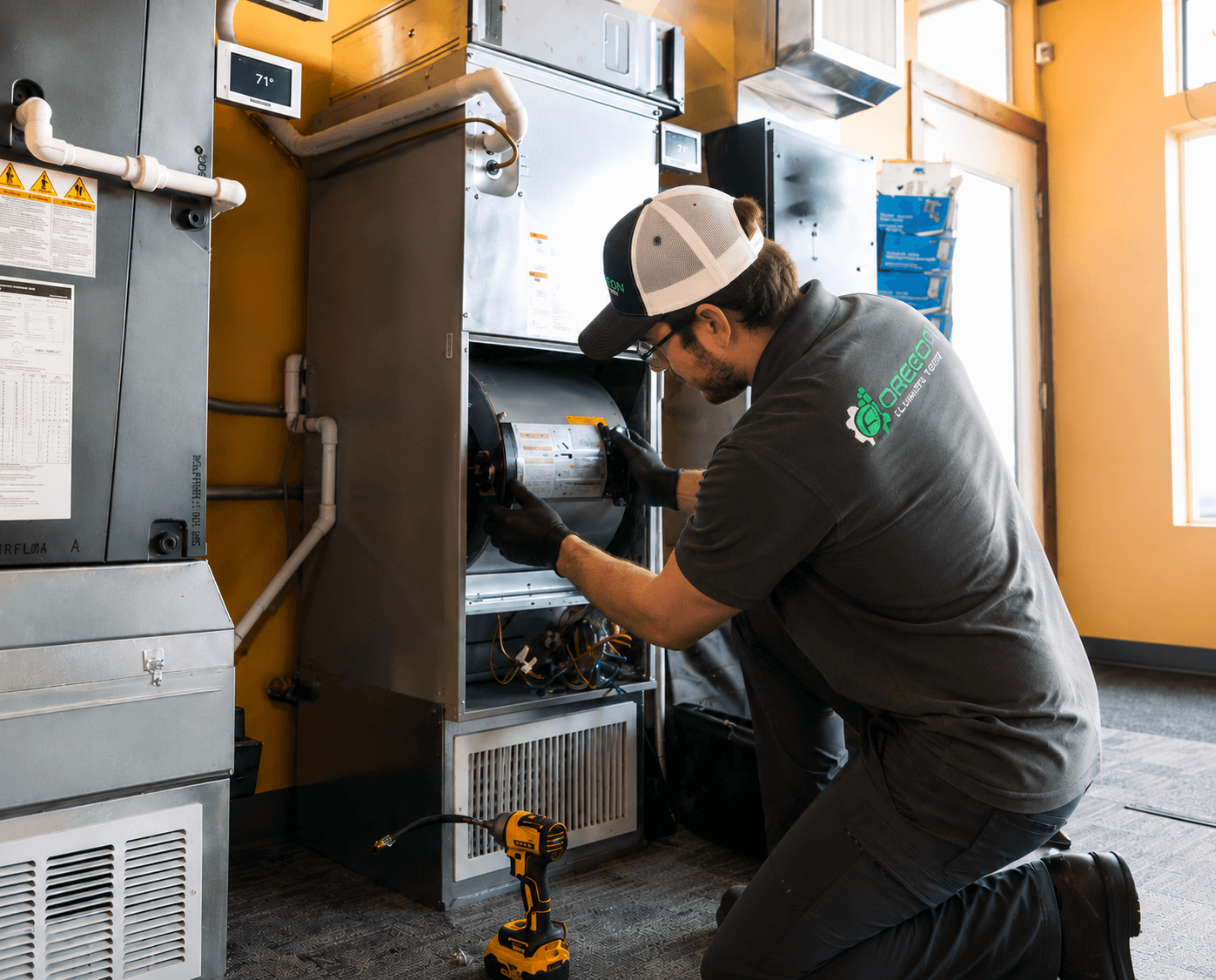 Adam Eells of Oregon Climate Tech servicing a furnace.